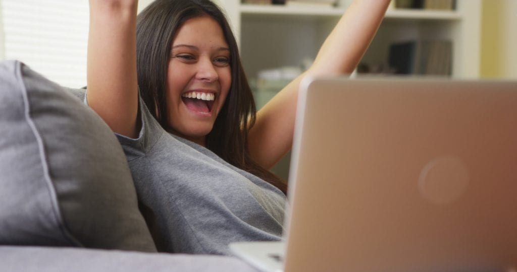 lady rejoicing in front of laptop for cash advance